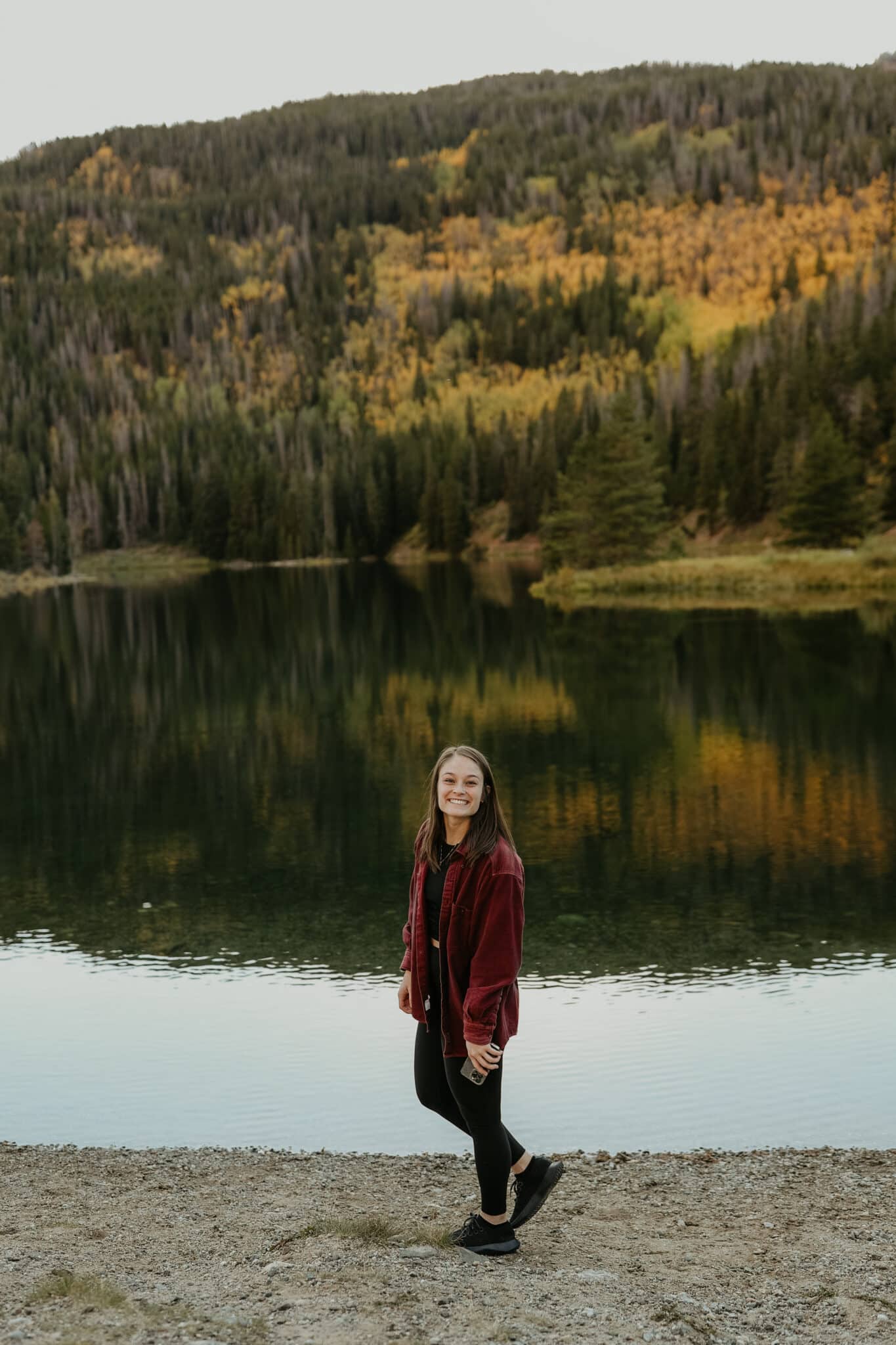 Bryn infront of a lake in the fall